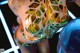 A close up of a mannequin wearing a gold and green dress.