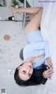 A woman laying on top of a white bed.